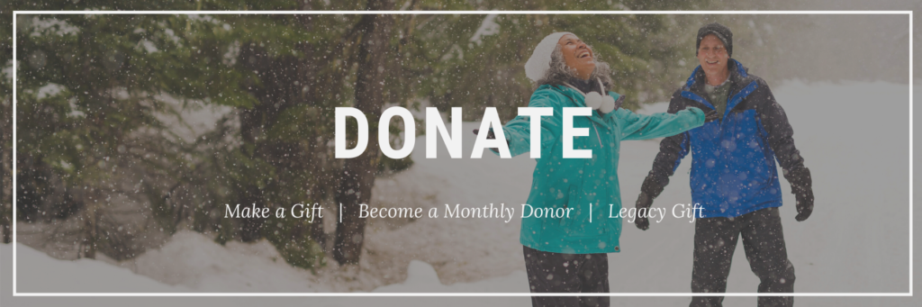 ID: Two people snowshoe in forest in teal and blue jackets with toque.Text: Donate here - Give Today, Monthly gift, Legacy Gift