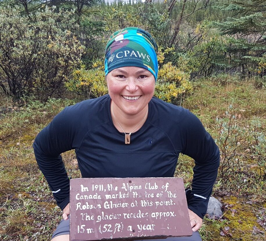 ID: Sarah wears blue CPAWS headwarmer and top on trail
