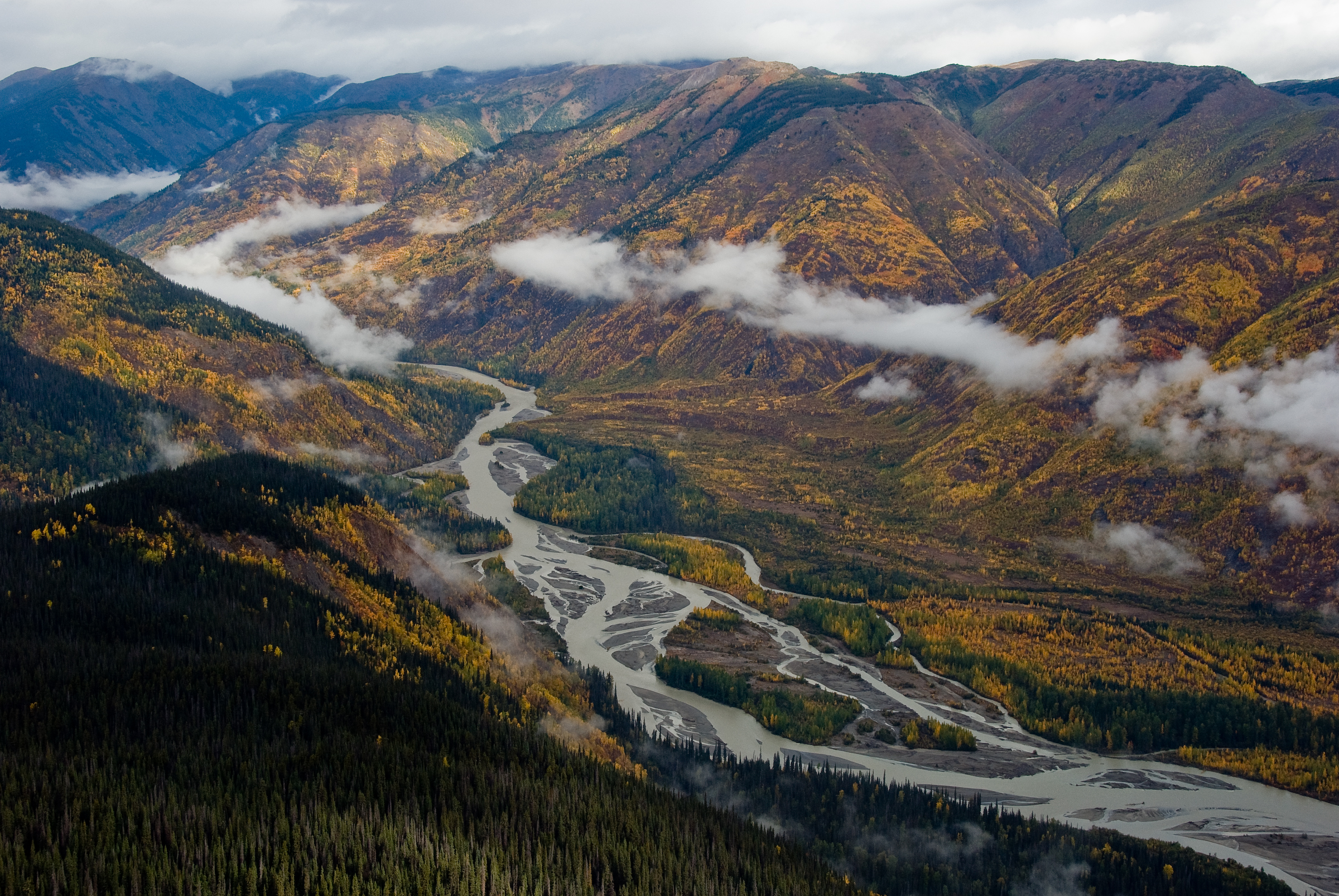 ID: river winds through lush autumn mountain valley